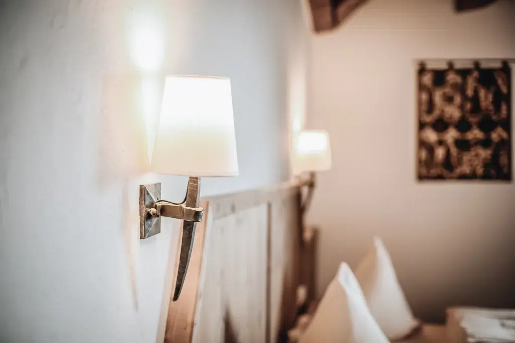 Nahaufnahme einer Wandlampe in einem gemütlichen Seefelder Doppelzimmer, sanft beleuchtet für mehr Behaglichkeit.
